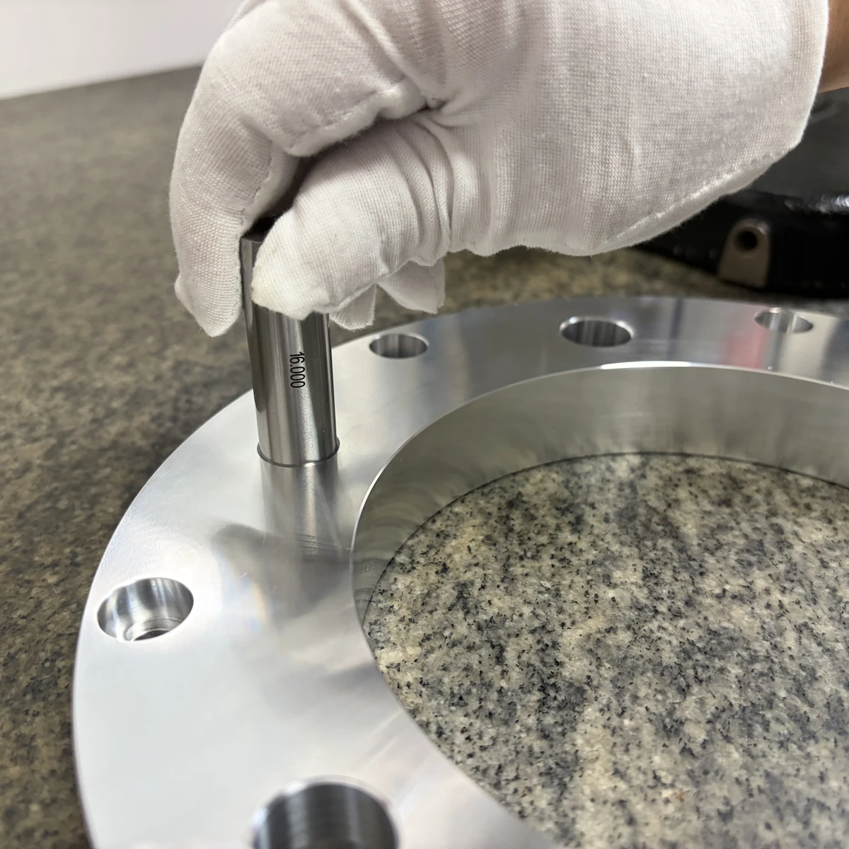 Pin gauge checking a bore in a finished flange ring