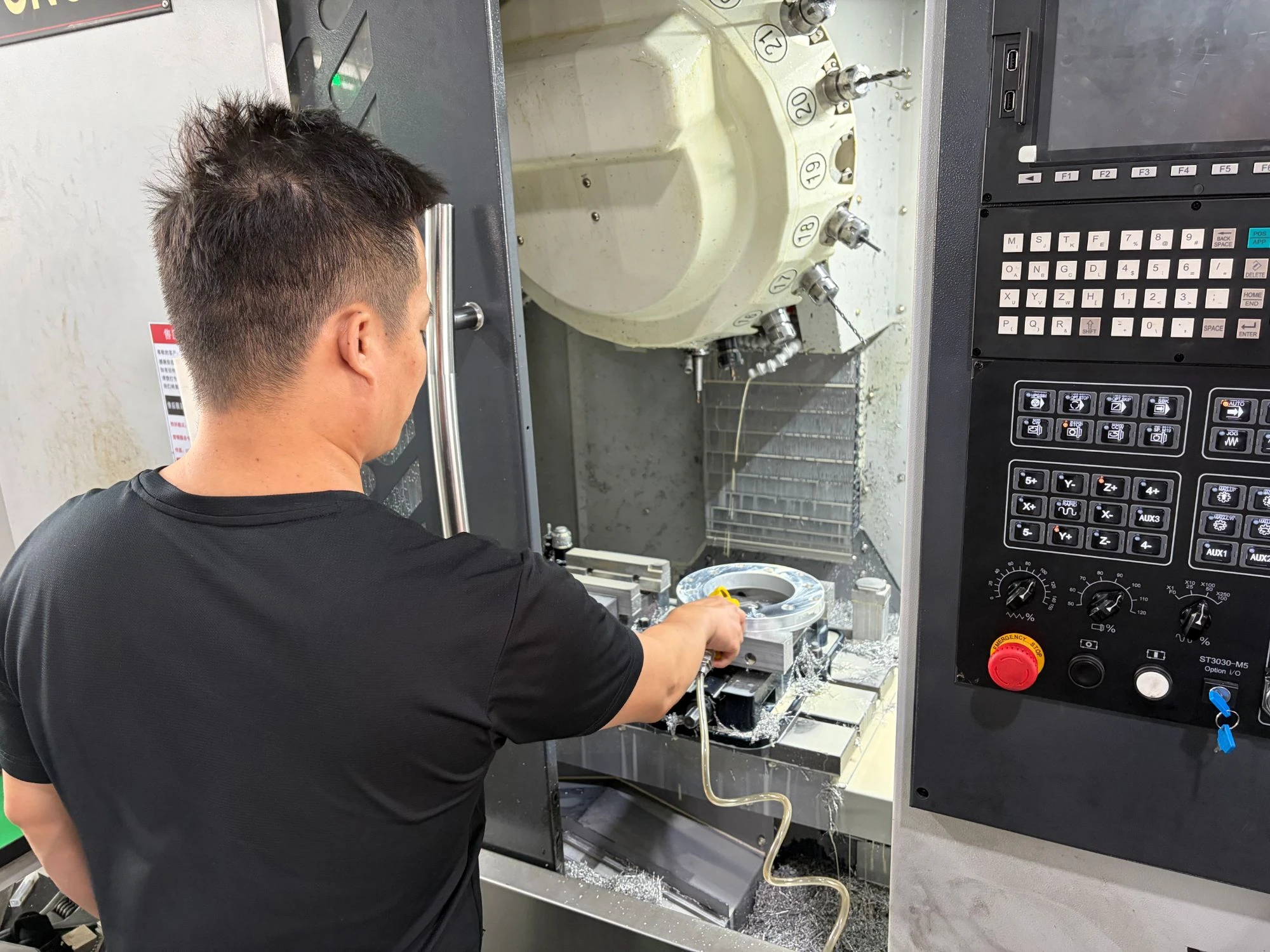 Operator machining a flange ring in a profile fixture