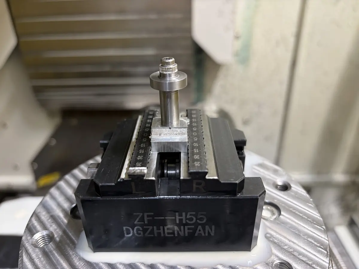 Housing on its mandrel fixture in a zero-point vise on the rotary table