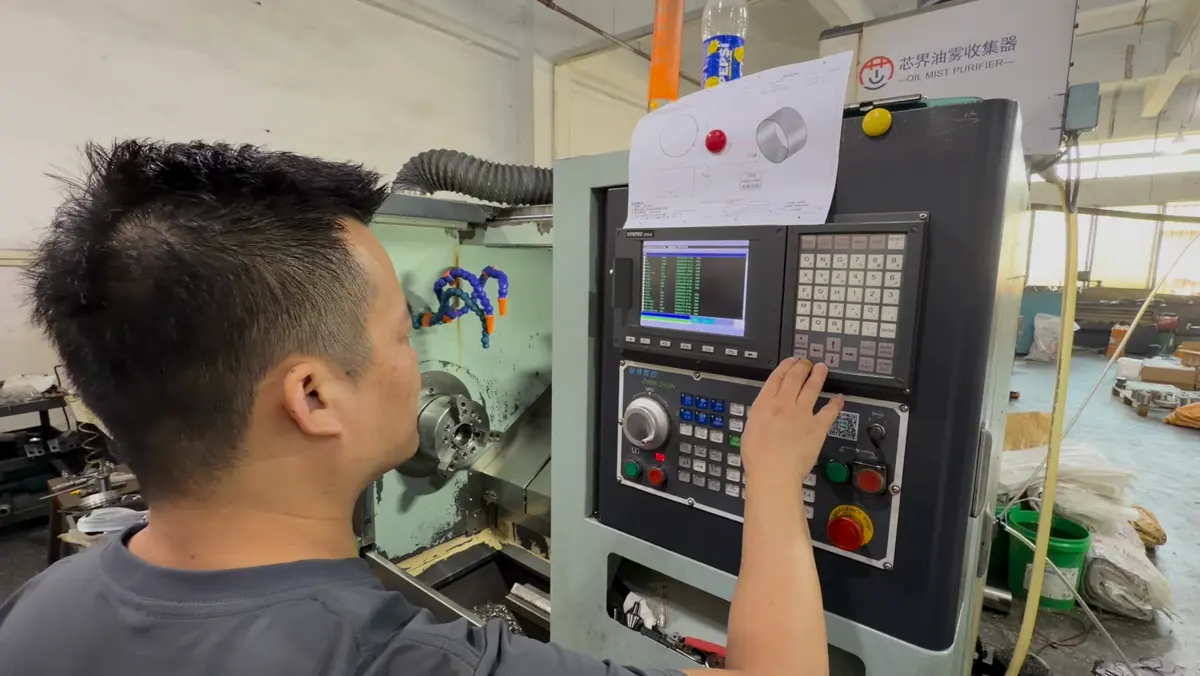 Raymond Liang setting up the CNC lathe control for the thin-wall ring job