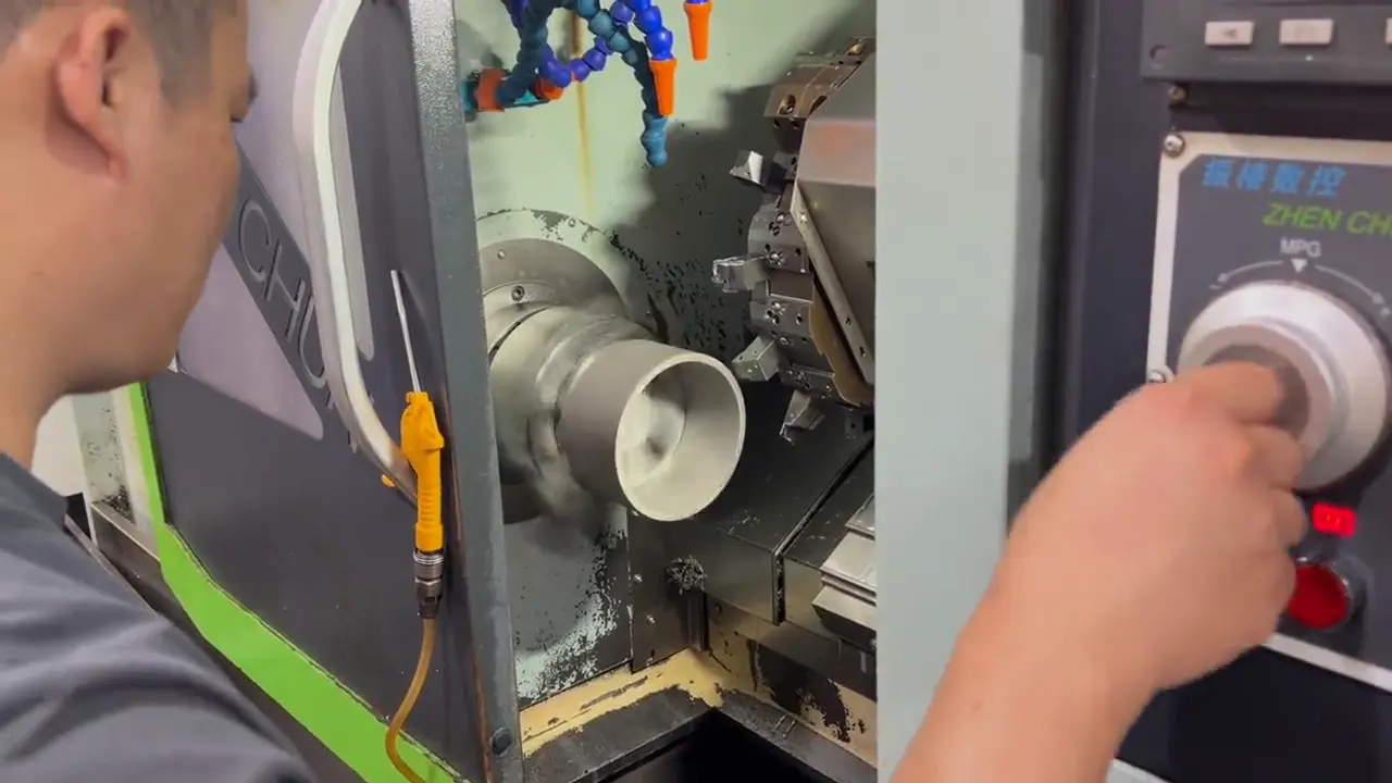 A thin-wall stainless ring being turned on a dedicated fixture on a CNC lathe