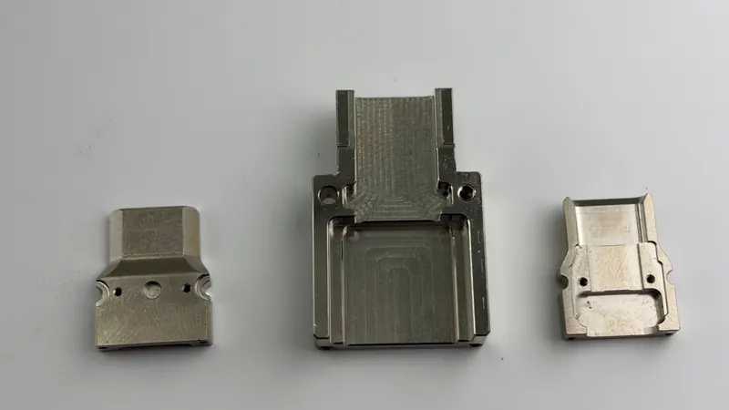 Three CNC milled aluminum housings with pockets and tapped holes