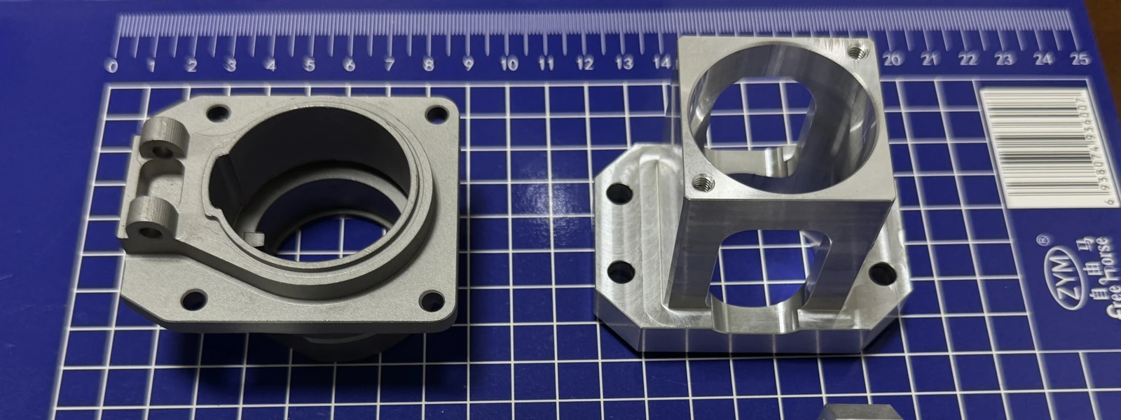 Group of CNC milled parts including aluminum and stainless steel components