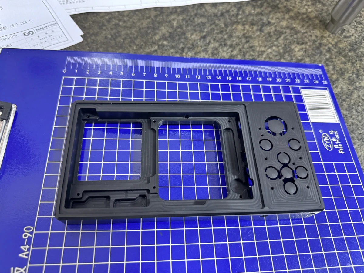 Black anodized 3-axis CNC milled frame with pockets and contour features