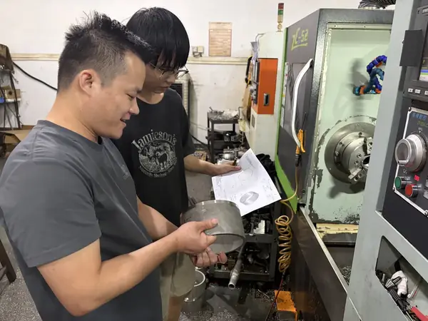 Raymond Liang reviewing a drawing