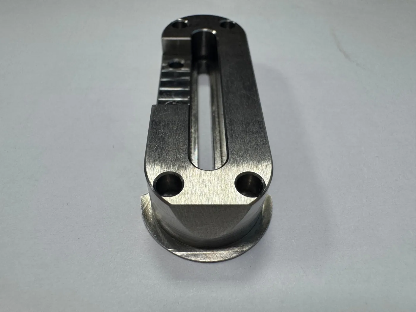Milled bracket with a rounded-end slot and chamfered holes
