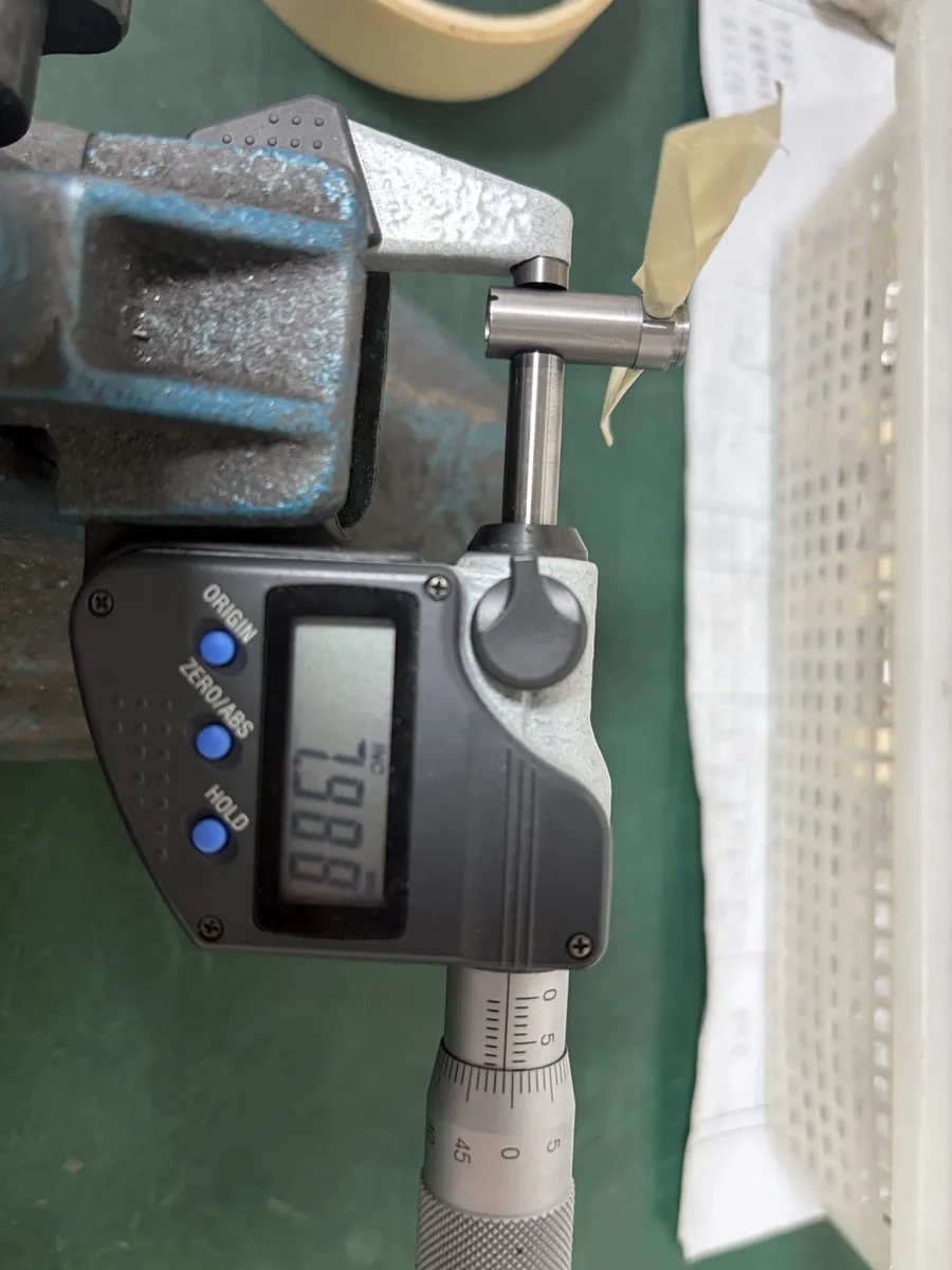 Digital micrometer measuring a turned pin