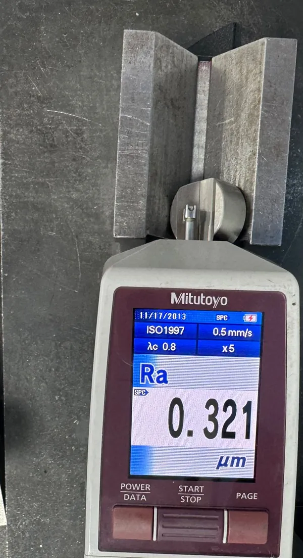 Mitutoyo SJ-210 roughness tester on a round part in a V-block reading Ra 0.321 micrometres